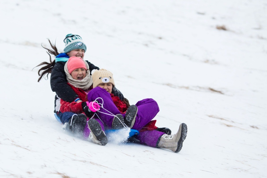 Three Girls Sledding Near Grand Forks Greenway in Grand Forks North Dakota Three Girls Sledding Near Grand Forks Greenway in Grand Forks North Dakota