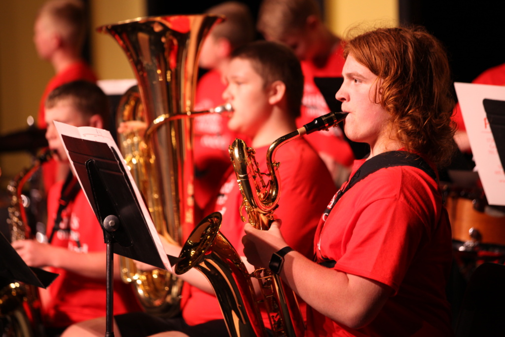 Young Men Playing Instruments in Cultural and Musical SPA Performance in Grand Forks Best City to Raise a Family
