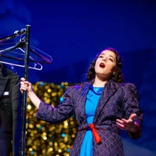 Empire-White-Christmas Woman singing on stage at Empire Theater Arts Center in Grand Forks, ND