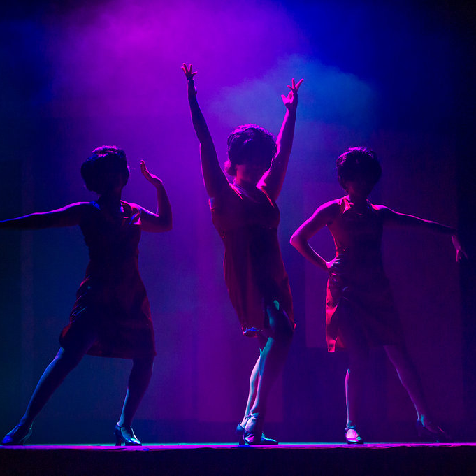 empire-CVB 3 Women standing on the stage at the Empire Theater in Grand Forks.