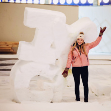 Posing-by-snow-sculpture-in-downtown-Grand-Forks,-ND Posing-by-snow-sculpture-in-downtown-Grand-Forks,-ND