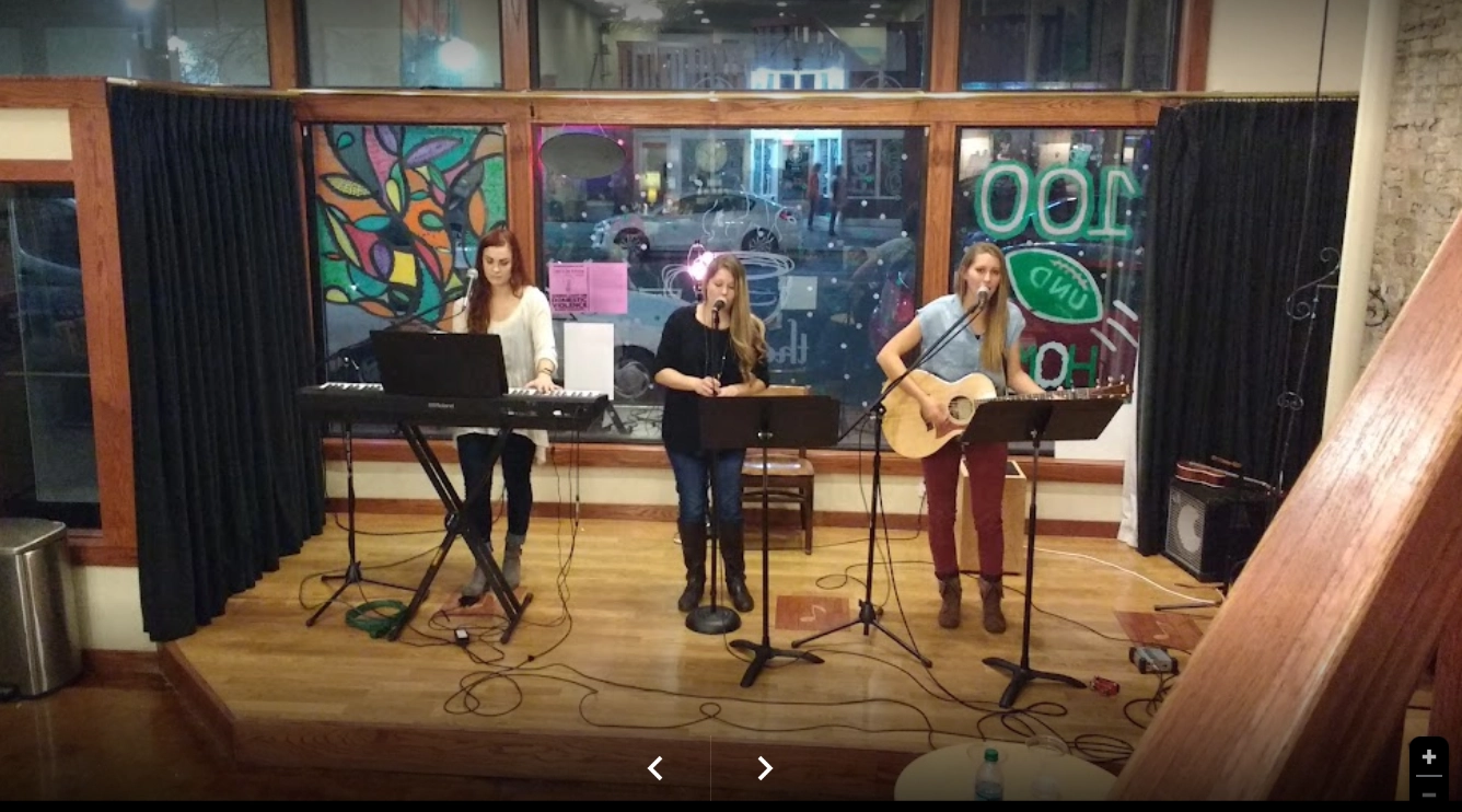 ember-coffeehouse-grand-forks-live-music 3 woman singing on stage at the Ember Coffeehouse in Grand Forks.
