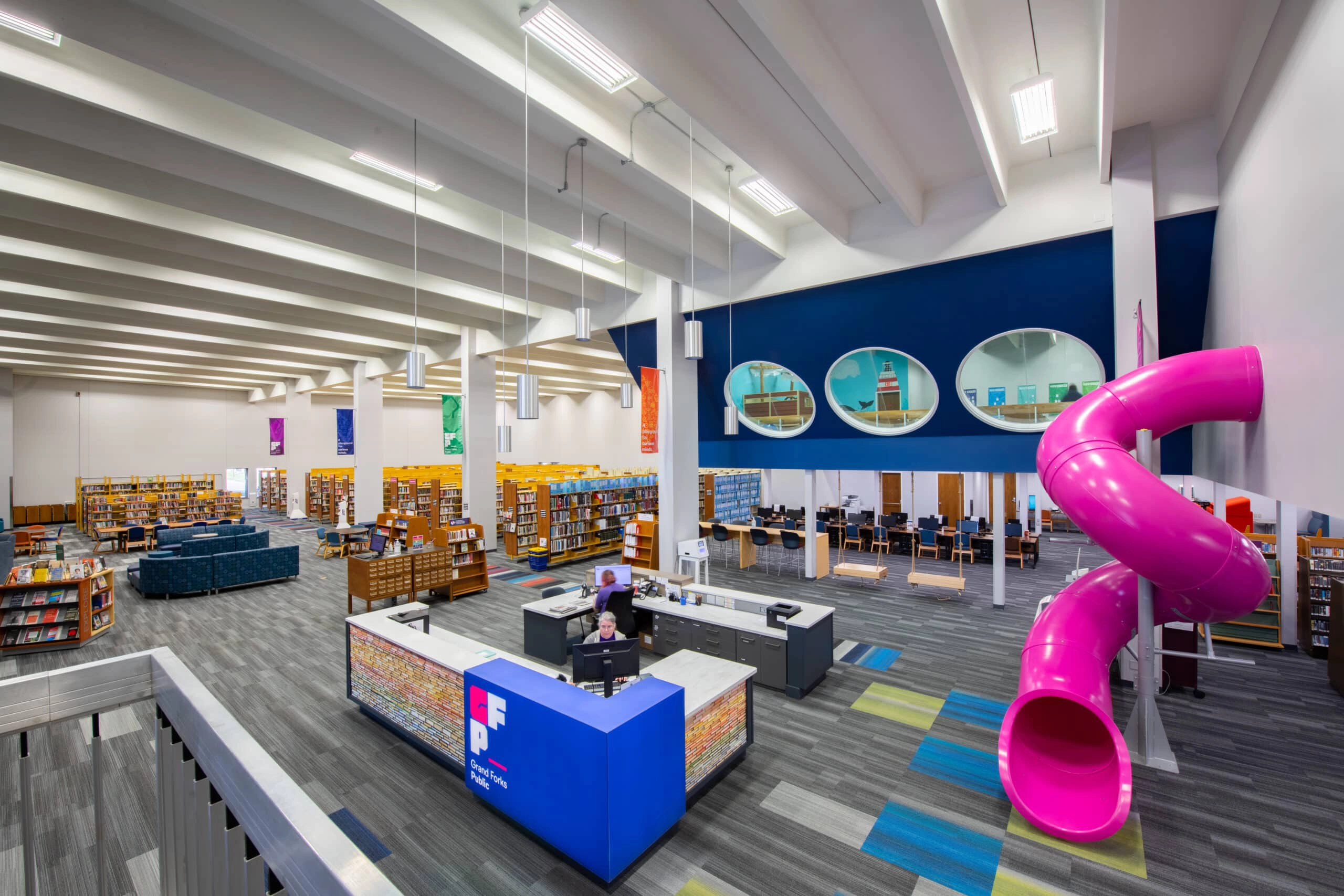 grand-forks-public-library Grand Forks Public library with books and a pink slide.