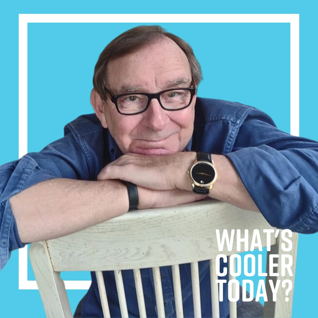 terry-cooler-headshot 'WCT?' Grand Forks author Terry sitting on a chair in front of blue background.