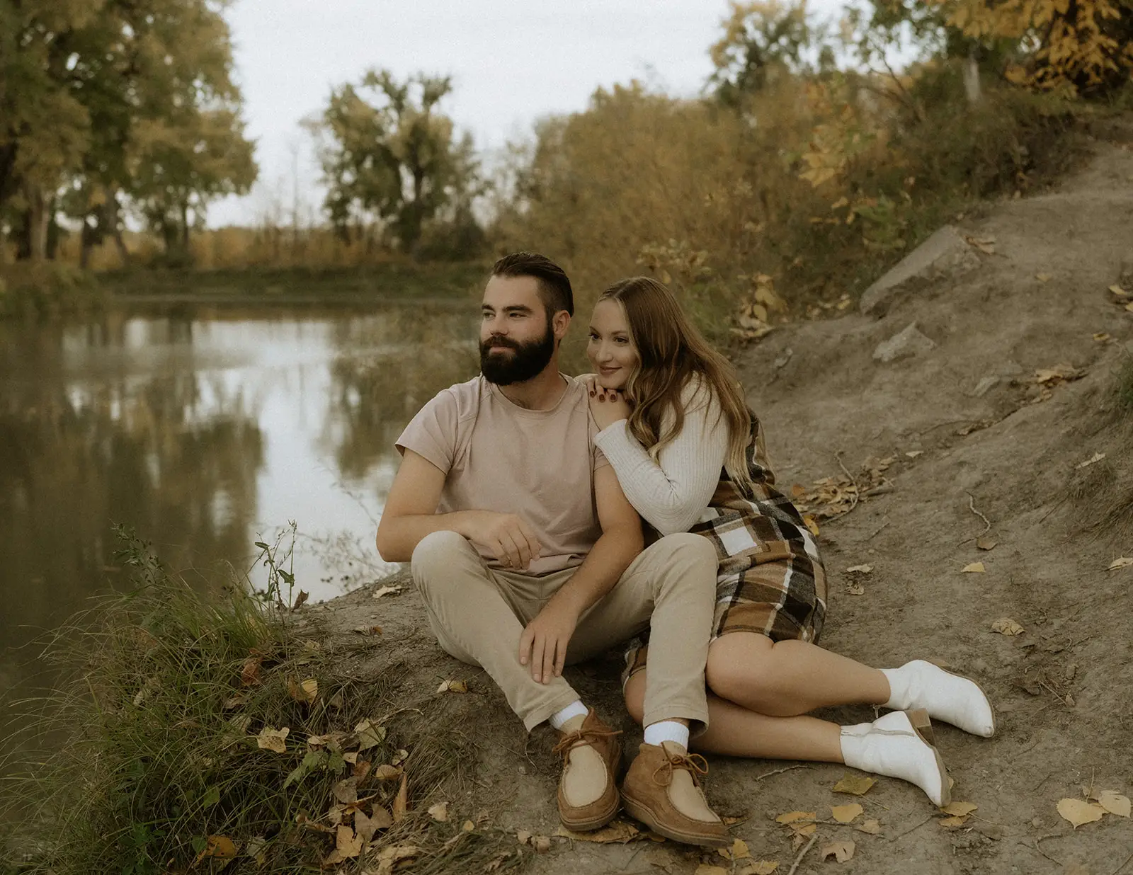 Couple-Sitting-River-Grand-Forks-Region Couple sitting by the river in Grand Forks Region