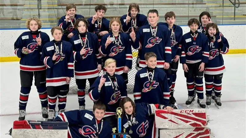 Grand-Forks-Boys-Hockey Grand Forks Boys Hockey team poses for victory picture on the Ice Rink