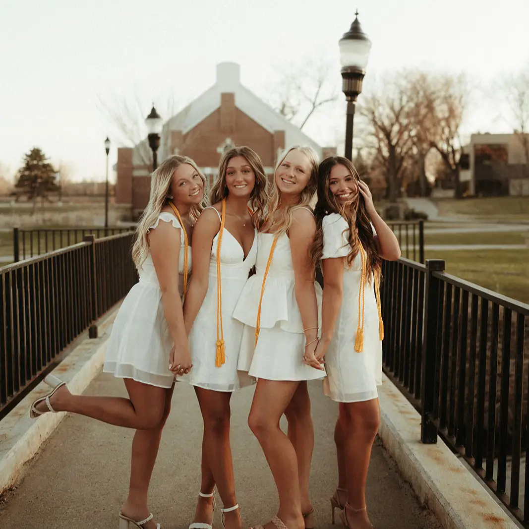 Grand-Forks-Graduation-UND-Campus Girls pose on the bridge on UND Campus in Grand Forks