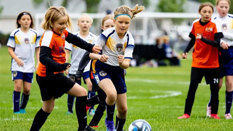 Grand-Forks-Soccer-Club Girls fighting over the soccer ball on the field in Grand Forks.