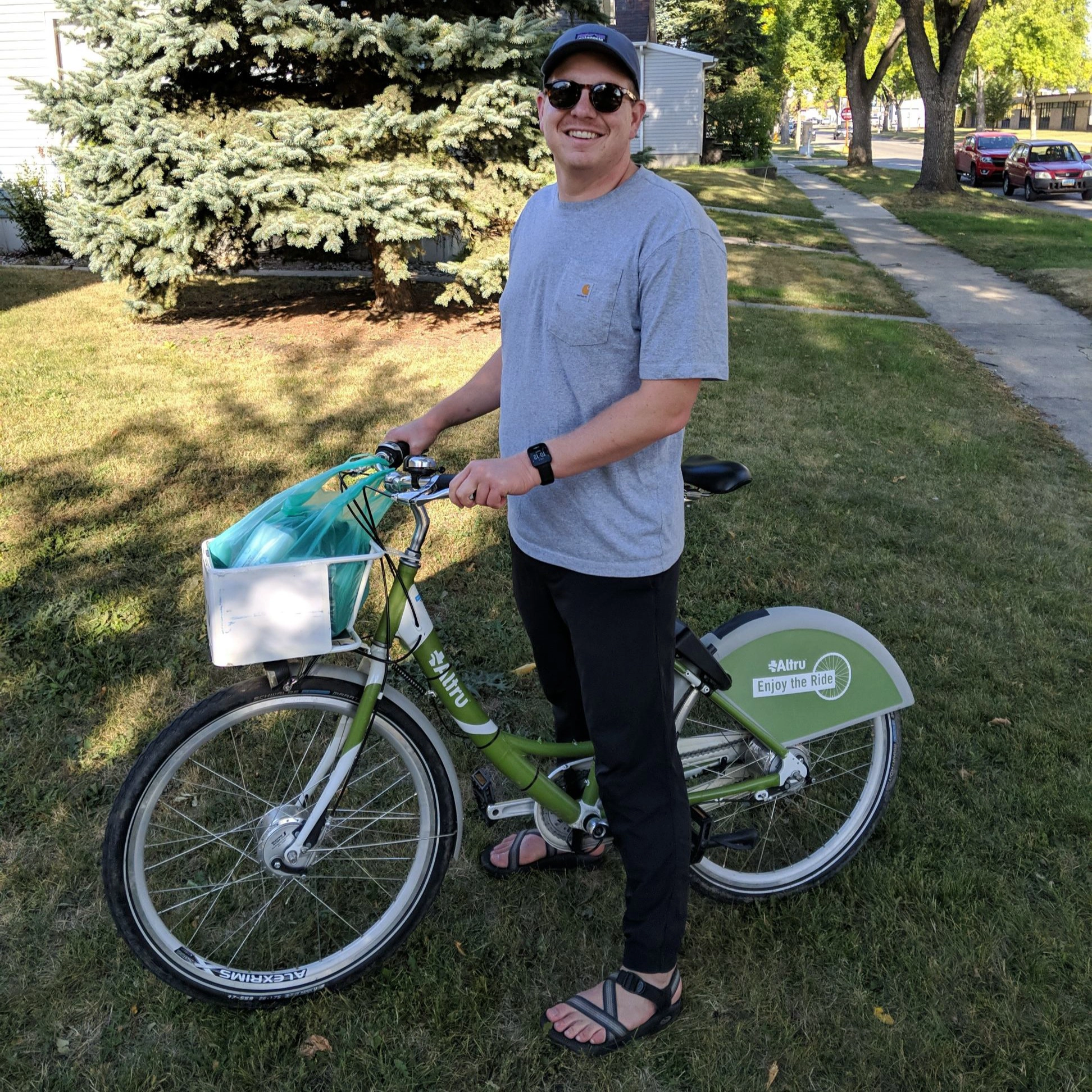 paul-biking-picture WCT writer Paul stands and smiles at the camera while on an Altru Bike Share bike.