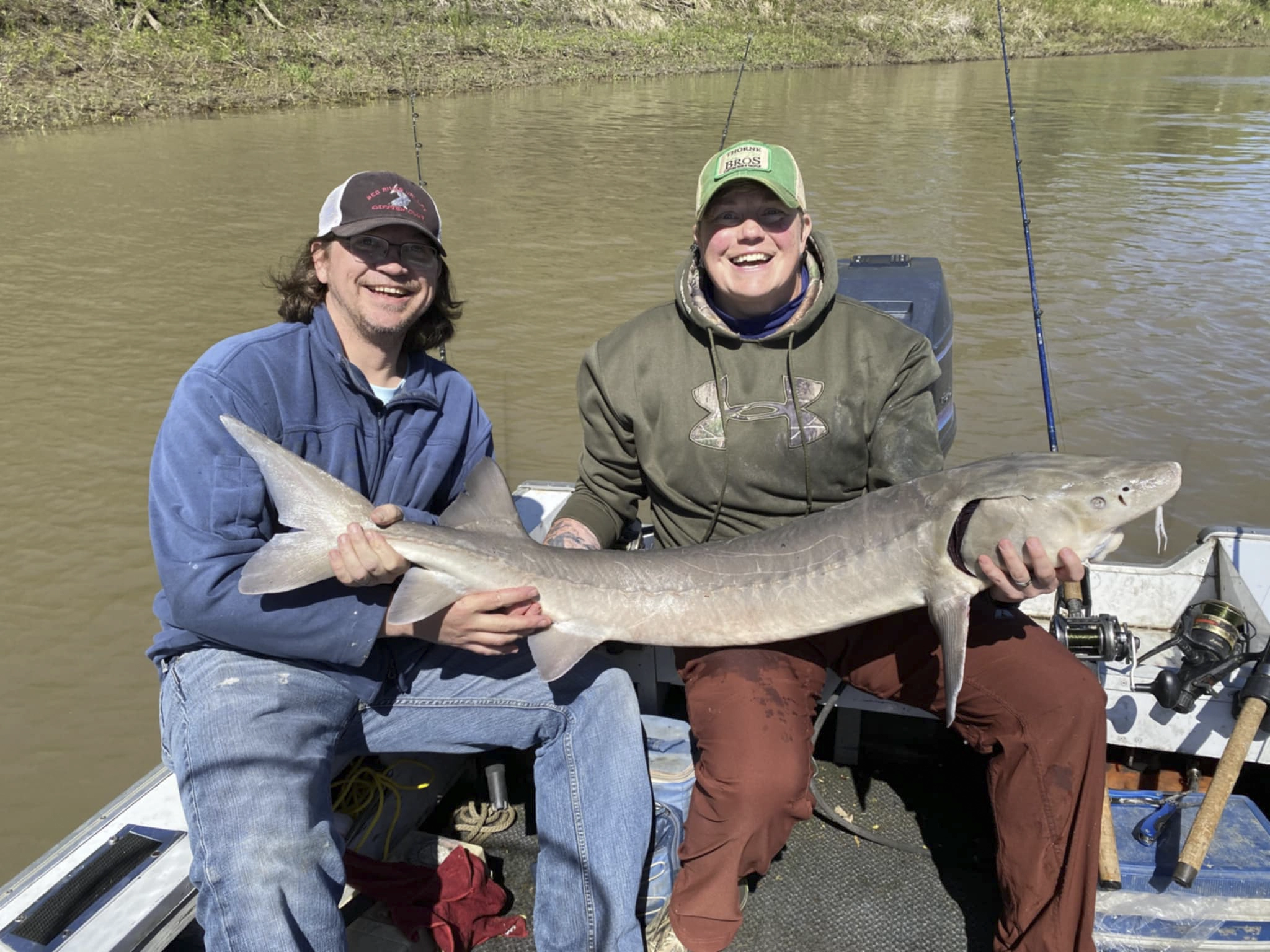 56-inch-sturgeon-grand-forks Wade Anderson and Andrea Charliebois holding a 56-inch Lake Sturgeon, May 2024.