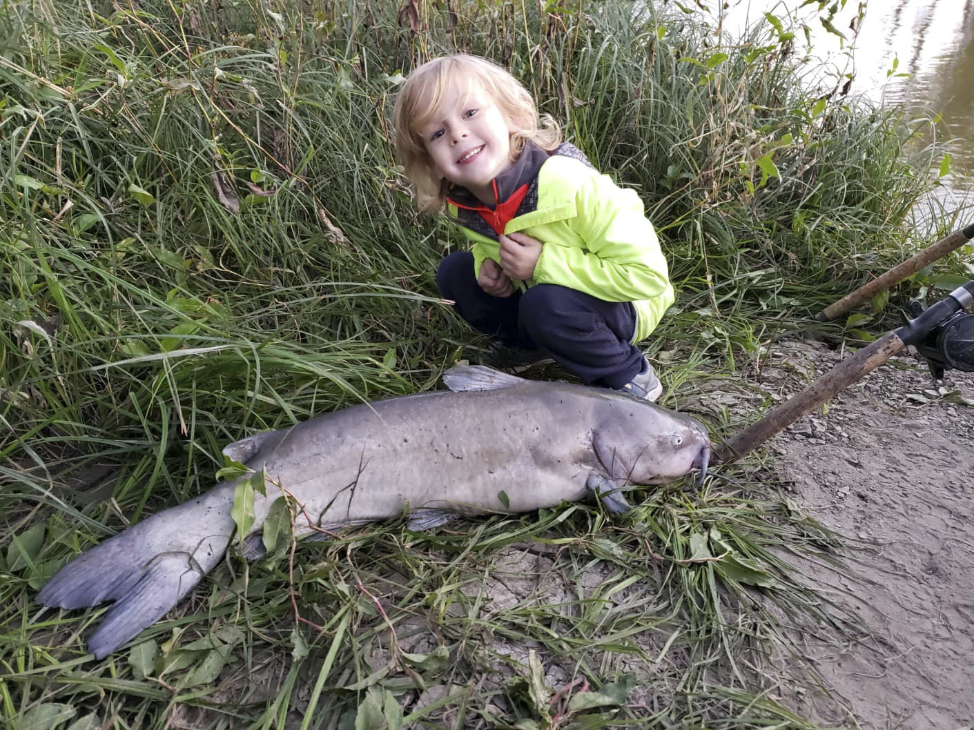 baby-avery-with-catfish-on-riverbank Avery Anderson posing with a Channel Catfish he helped catch off the riverbank near his house. Fish Species: Channel Catfish.