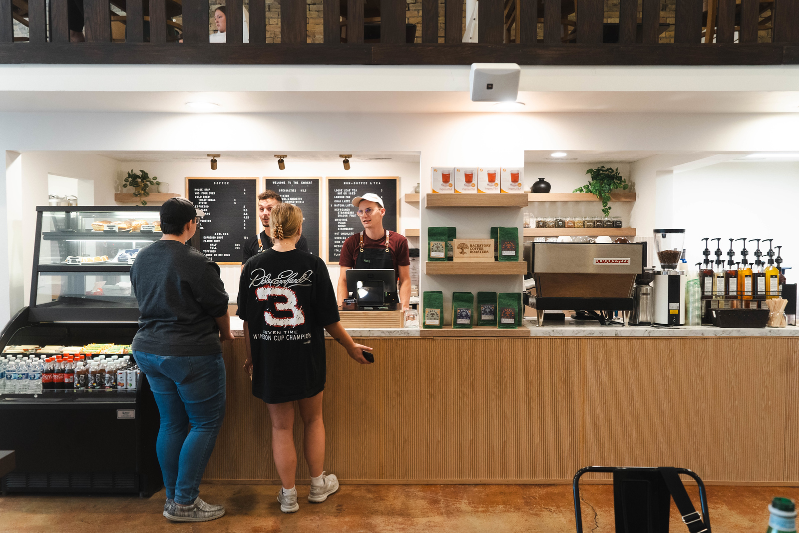 Coffee in Grand Forks - Ember The counter at the Ember, where two young people place their order with the two employees on the other side of the counter.