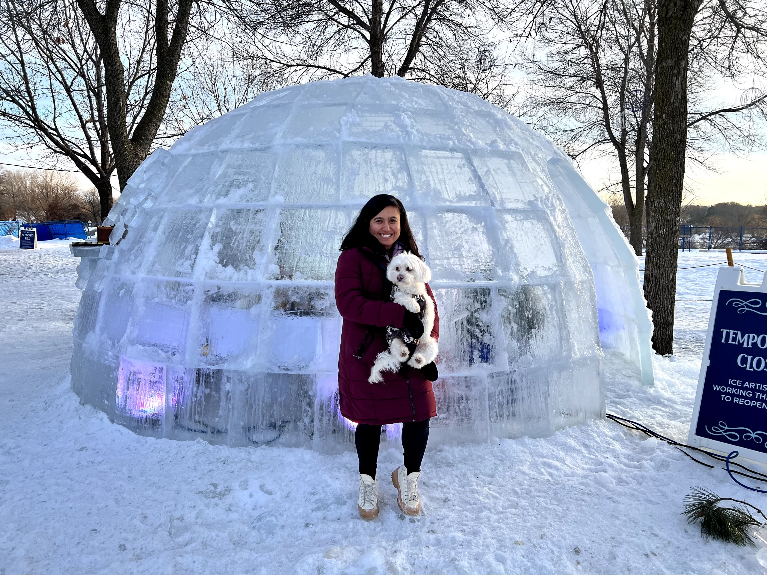 international-students-in-grand-forks-winter-survival Benu and her puppy outside of an igloo in Grand Forks.