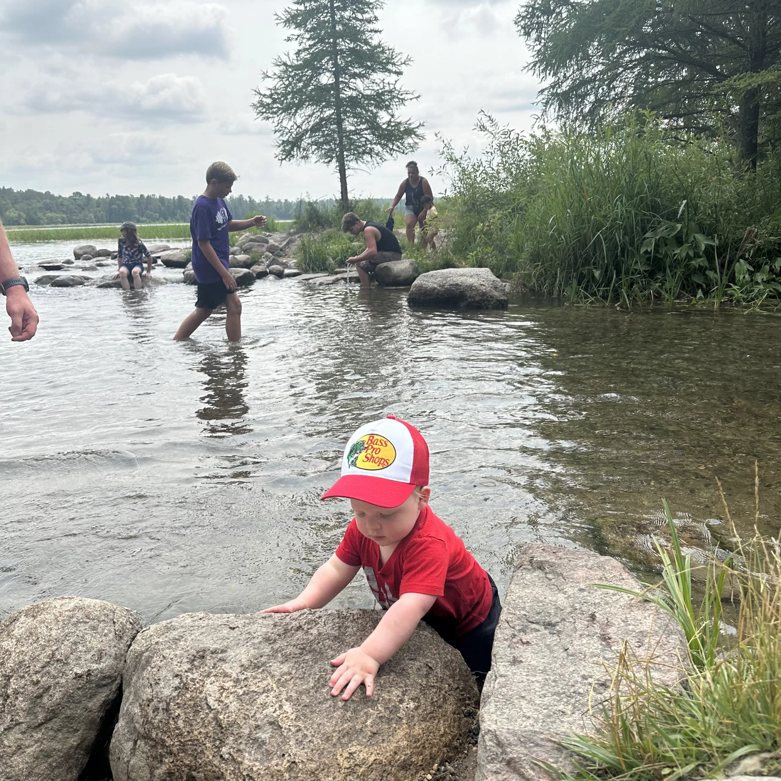 river-day-trips-from-grand-forks Baby playing with rocks in the river near Grand Forks.