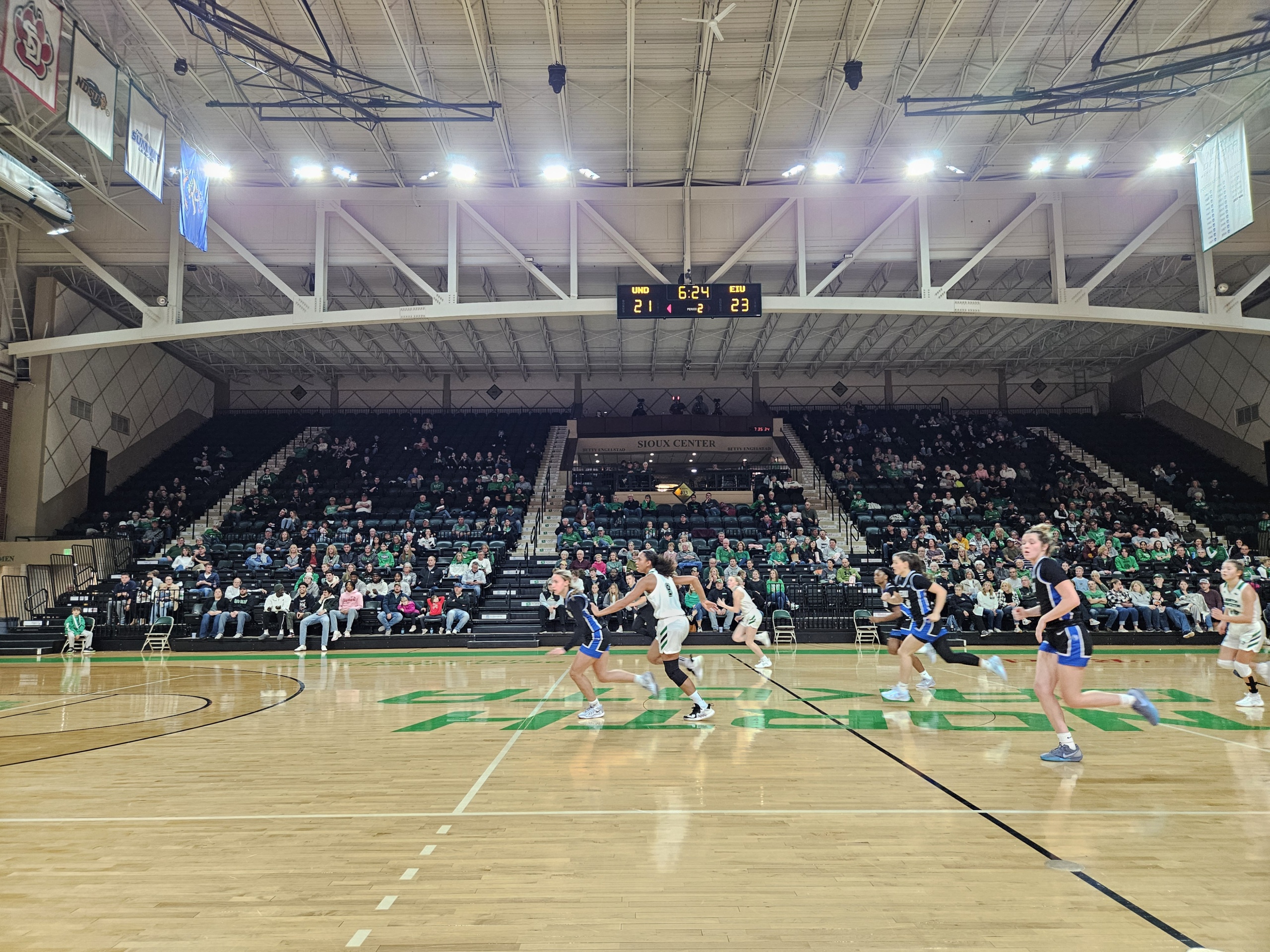 UND Athletics -Betty Engelstad Arena The UND women's basketball team rushes toward the basket mid-game at the Betty Arena.
