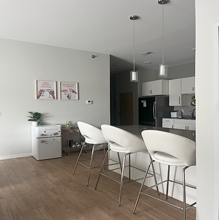 SonomaLofts Interior Sonoma Lofts. White walls in a small but decent sized kitchen. Cute pink decorations and a mini-fridge in the corner.
