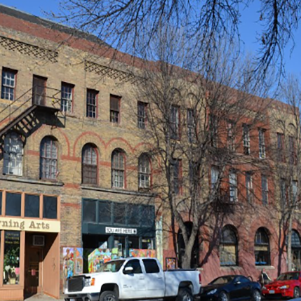 Odd Fellows Apartments Exterior Outside the Odd Fellows Apartment building. An old building downtown above a coffee shop. Arches and red and brown brick on the outside.