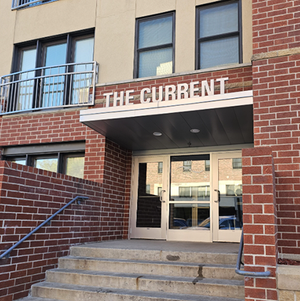 the current apts - APPROVED Front Entry Exterior of The Current Apartments. Lots of red brick and concrete steps. A big metal sign that reads "The Current" above the door hang.