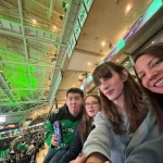 Author Bru is pictured with his wife and kids at a UND hockey game sitting in the stands!