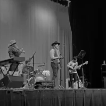 Empire Theater Country Band Author Adrian attends a grand forks Empire Theater concert. A country band performs on the stage and the image is in black and white.