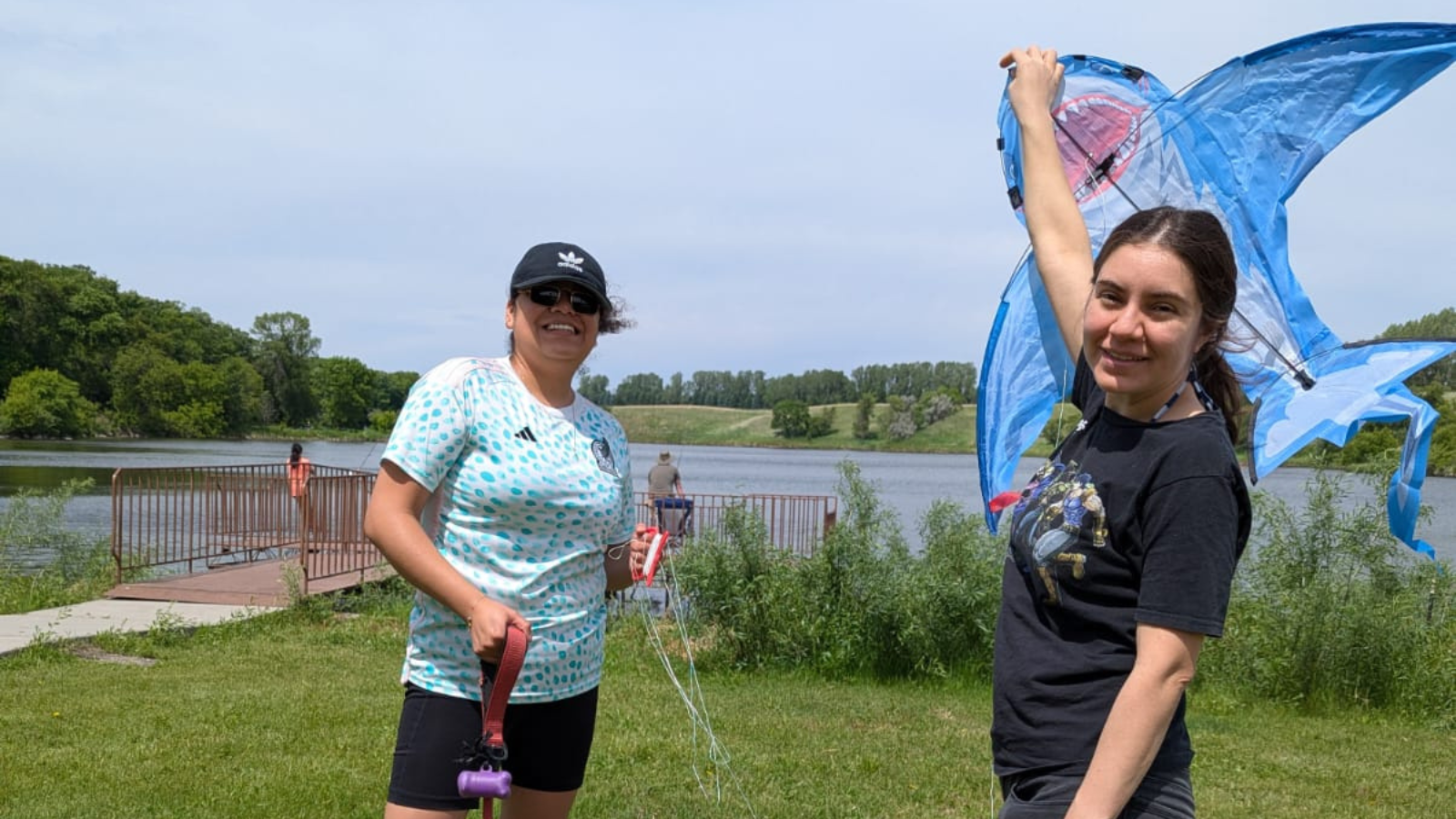 Kite and Larimore Dam Photo Two folks stand together at Larimore Dam with a shark kite ready to set sail in the skies!