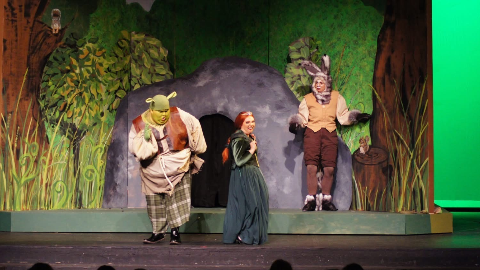 Shrek Musical Photo Photo of the Shrek musical in Grand Forks. Fiona, Shrek, and Donkey sing together on stage.