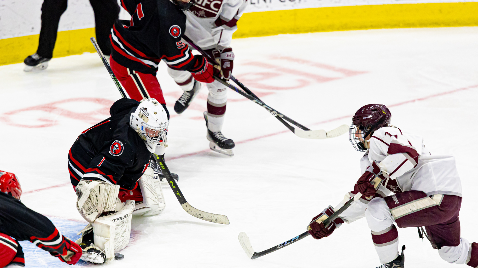 Hockey Championship State Champion faceoff where a Central player shoots for the goal, but the goalie blocks it!