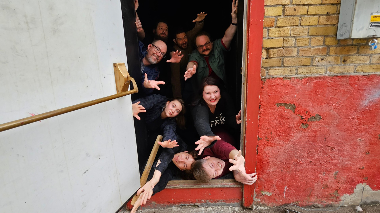 Improv Troupe Group Photo Photo of the Improv Troupe bursting through the firehall theatre door. Author Becca is pictured on the right second from the bottom.