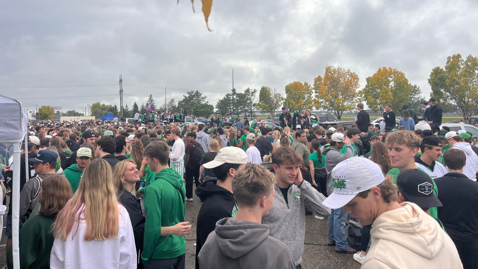 UND Tailgate Student Section This photo of the UND Tailgate student section. It is very packed with students mingling about in all directions.