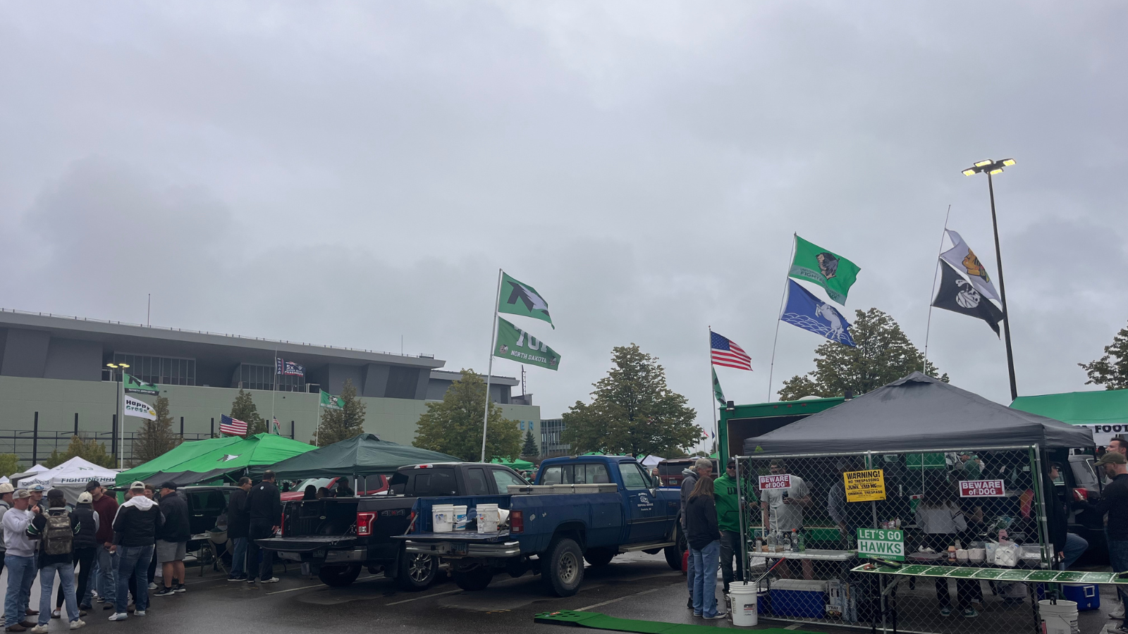 UND Tailgate photo UND Tailgate photo with many flags for UND flying in the photo. The Alerus is in the background.