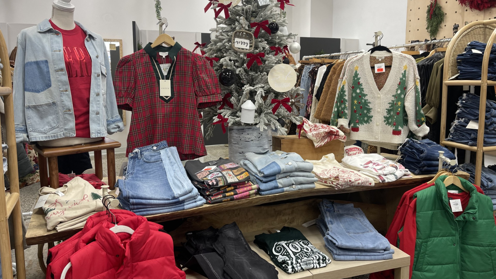The Silo Boutique Photo The Silo boutique Christmas display with red and green accented pieces. Light wash jeans and puffer vests too!