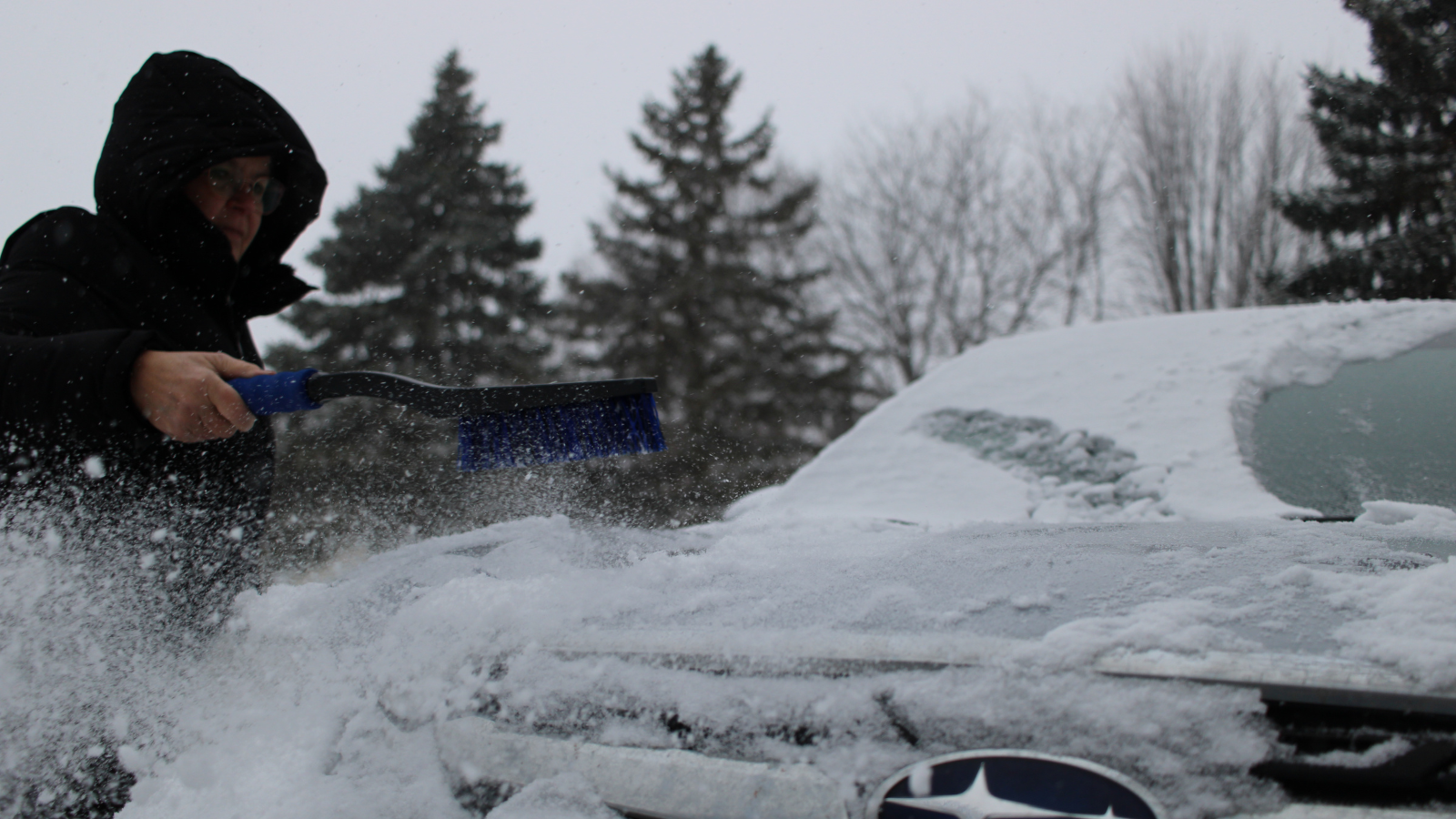 Snow Brush Photo Author Eli's friend brushes off the hood of her car with a snow brush/ice pick dual. Very handy!