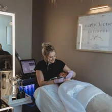 Women Owned Business Featured Image Carly Irene Artistry works on a client in her suite