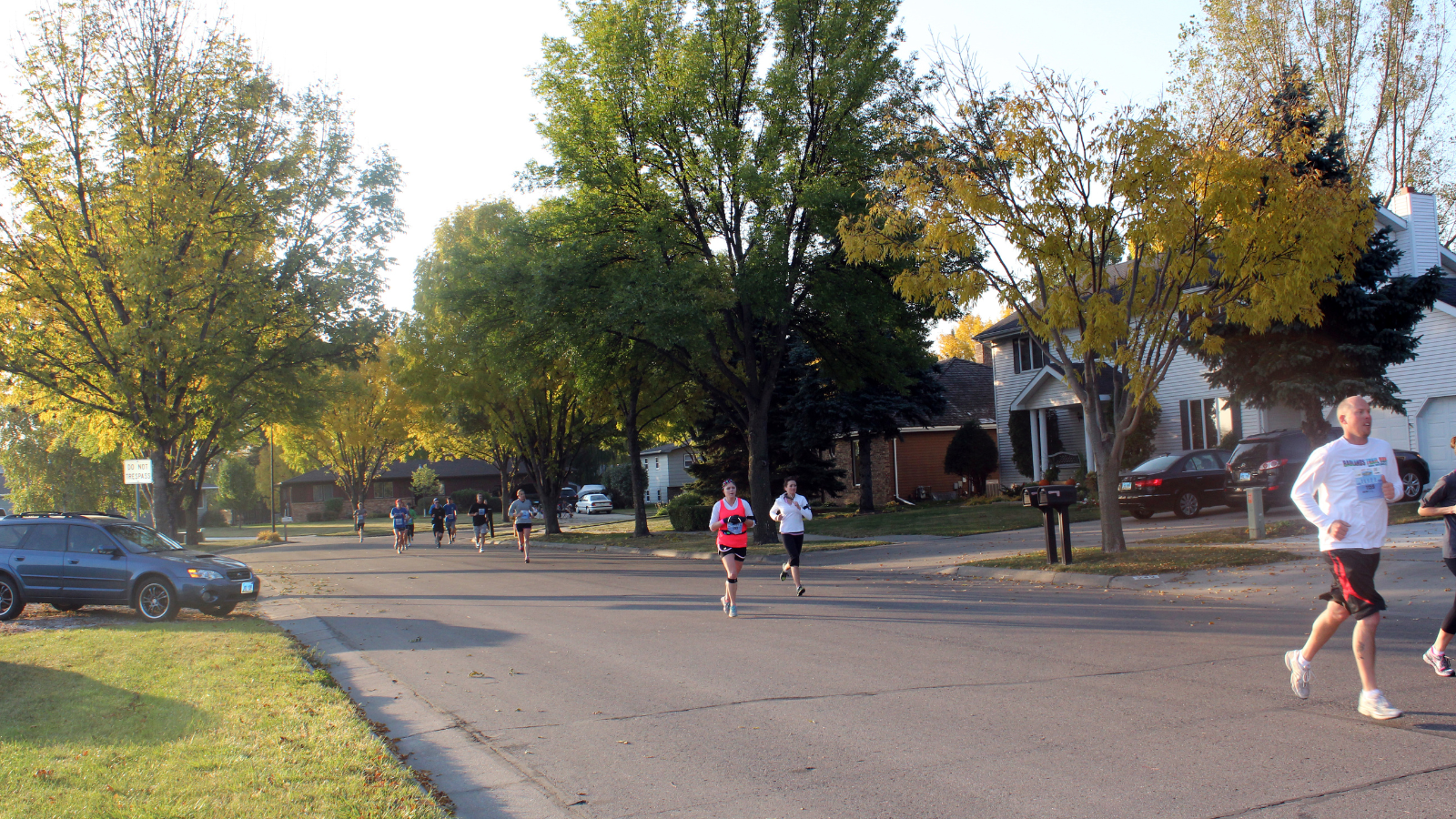 Neighborhood Race Strolll A group of runners in a race comes through a Grand Forks neighborhood in the late summertime