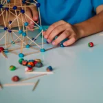 Children play with play-dough and sticks to build things
