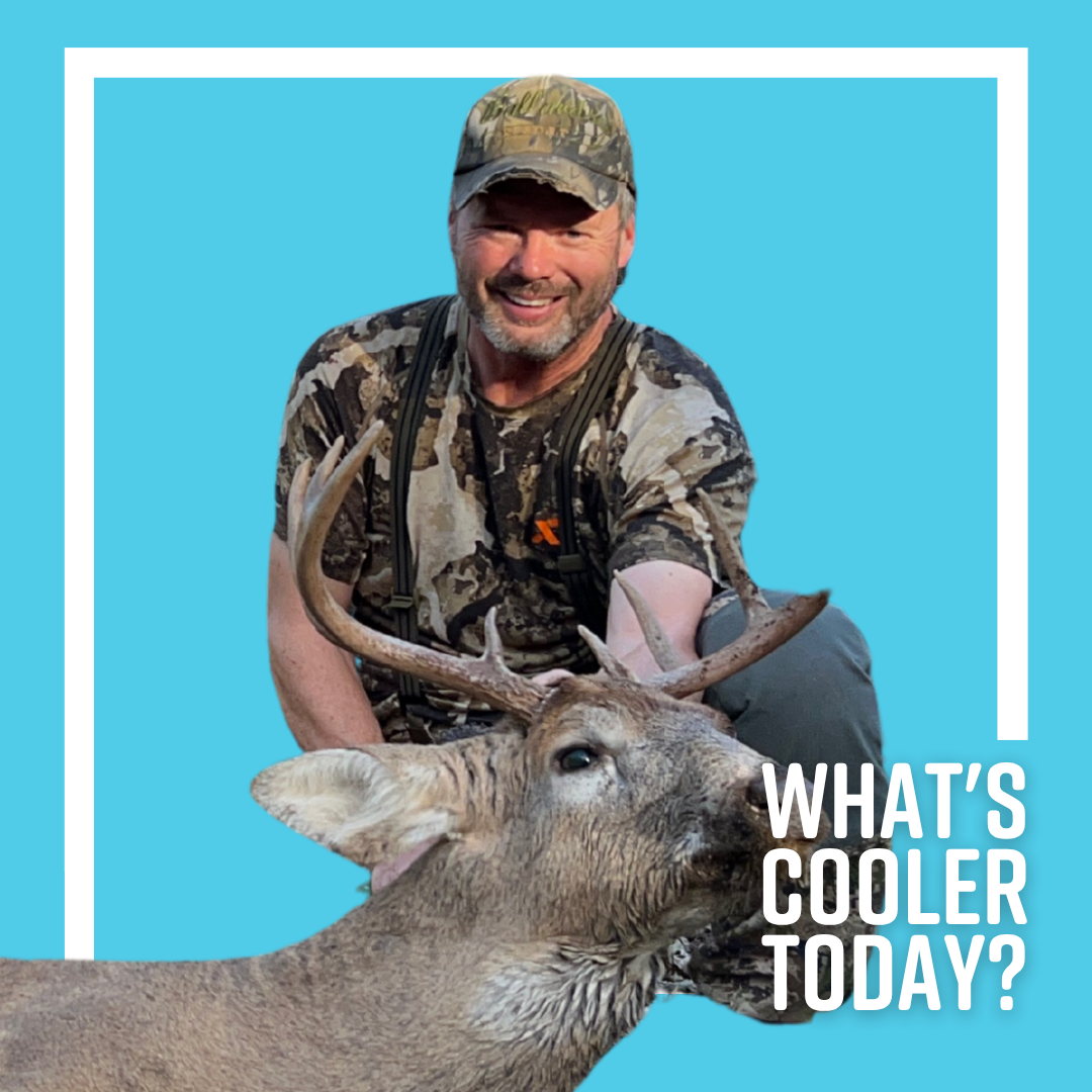 Author JT smiles at the camera with a buck he shot